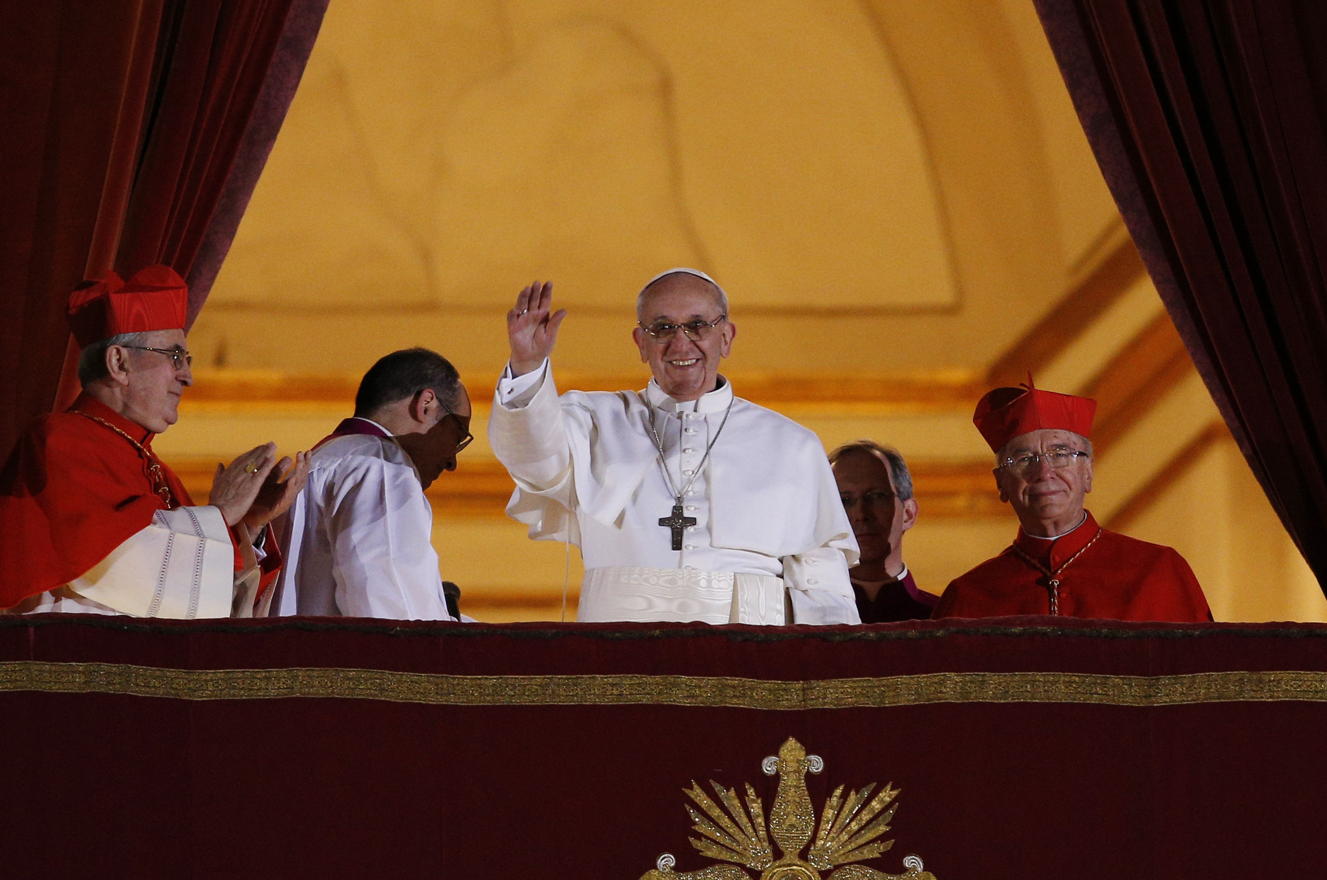  Pope Francis waves from the central balcony of St. Peter's Basilica following his election March 13, 2013.