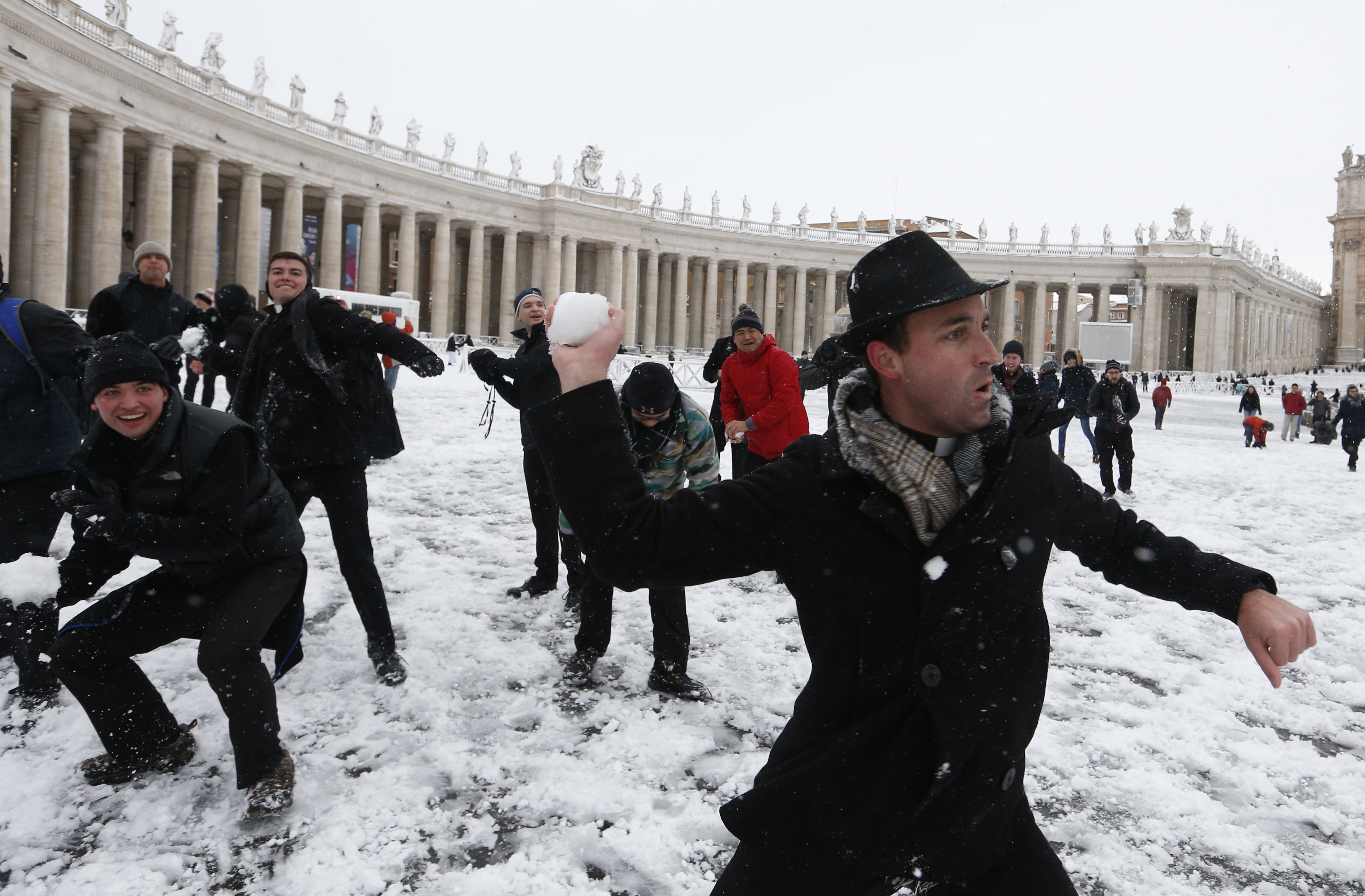 Father Robert Kilner, right, and seminarians from the Pontifical North American college engage in a snowball fight with their peers from the Venerable English College in St. Peter's Square at the Vatican after a rare snowfall Feb. 26. (CNS photo/Paul Haring)