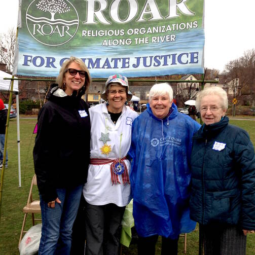 Dominican Sisters of Hope Bette Ann Jaster (center, left) and Nancy Erts (center, right) joined with other members to represent Religious Organizations Along the (Hudson) River at the Rally. 