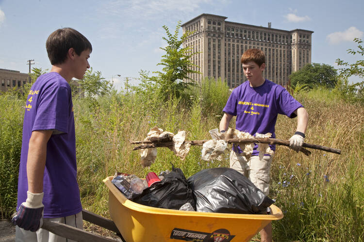 High school volunteers from St. Mary of the Hills Church in Rochester Hills, Mich., clean trash and debris from an alley in Detroit's Corktown neighborhood. (CNS photo/Jim West) 