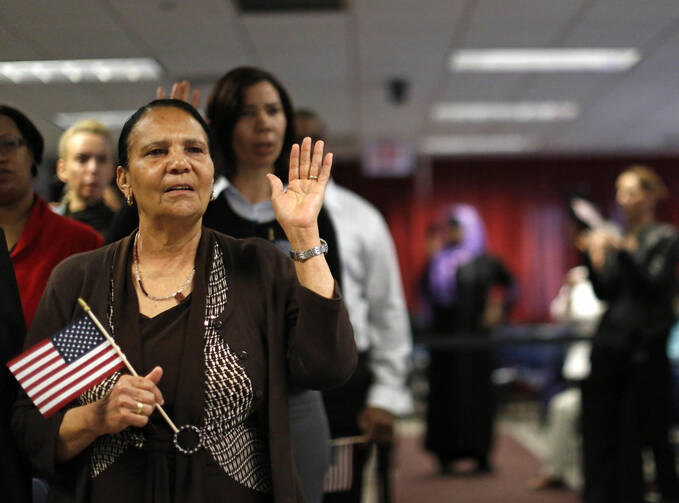 Immigrant Isabel Rivera from the Dominican Republic takes the oath of citizenship during a naturalization ceremony in New York. (CNS photo/Brendan McDermid, Reuters) 