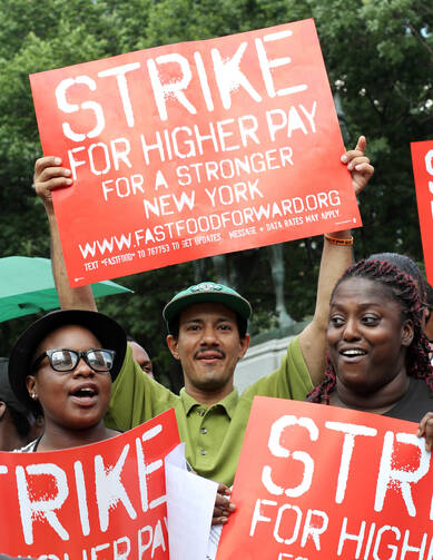 Fast-food workers and supporters demand higher wages during rally in New York. (CNS photo/Gregory A. Shemitz)