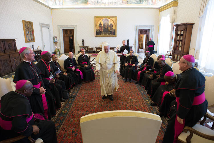 Pope Francis walks to his seat during a meeting with bishops from South Africa at the Vatican April 25. The bishops were making their "ad limina" visits to the Vatican to report on the status of their dioceses in 2014. (CNS photo/L'Osservatore Romano) 