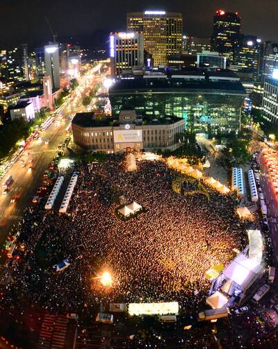 People gather at the Seoul Plaza in front of the City Hall in downtown Seoul July 24. Asian Youth Day will coincide with Pope Francis' visit to that country, where he is scheduled to beatify 124 Korean martyrs.