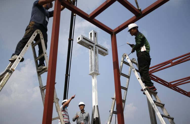 Laborers install cross in Seoul, South Korea, for Pope Francis' visit. (CNS photo/ Kim Hong-Ji, Reuters)