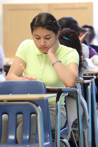 Giselle Ayala, 14, of Norcross, Ga., takes a diagnostic placement test at Cristo Rey Atlanta Jesuit High School Aug. 4. Some 160 first-year students took the placement exam at the newest Catholic high school in the community.