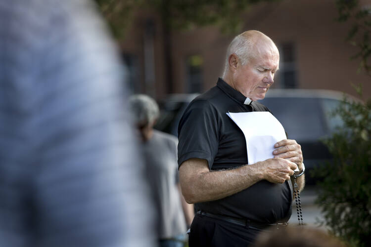 Ferguson, Mo., priest leads prayer vigil for peace after shooting of teenager. (CNS photo/Lisa Johnston, St. Louis Review)