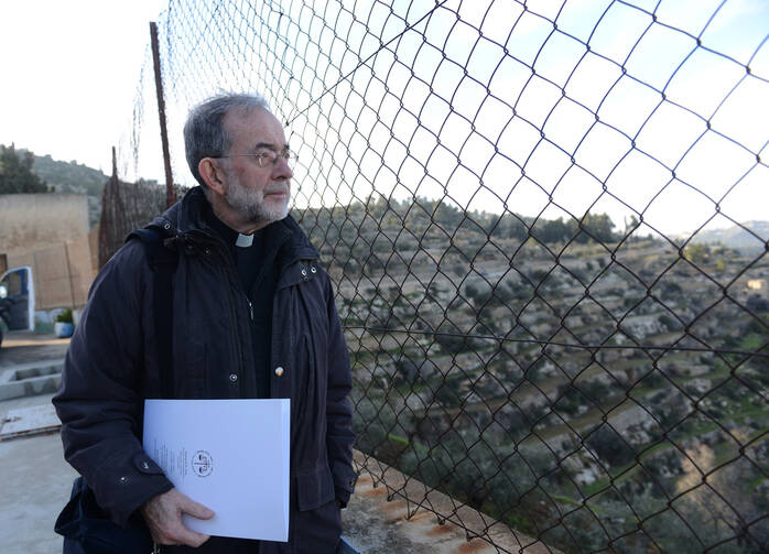 Canadian bishop looks through fence at convent in Beit Jalla, West Bank.