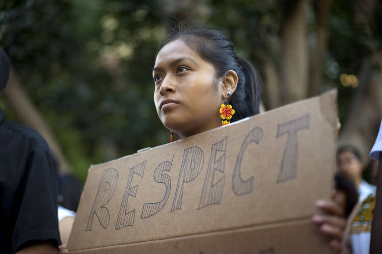 Woman in San Diego attends a vigil and rally July 2014, to show support for undocumented Central American minors. (CNS photo/David Maung, EPA)