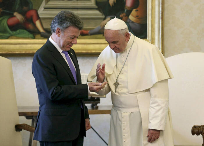 Pope Francis gives a blessing to Colombian President Juan Manuel Santos during a meeting at the Vatican June 15. (CNS photo/Alessandro Di Meo, pool via Reuters) 