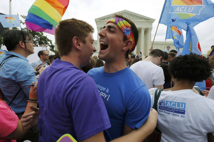 Gay rights supporters celebrate outside the U.S. Supreme Court building in Washington June 26 after the justices ruled in a 5-4 decision that the U.S. Constitution gives same-sex couples the right to marry. (CNS photo/Jim Bourg, Reuters)