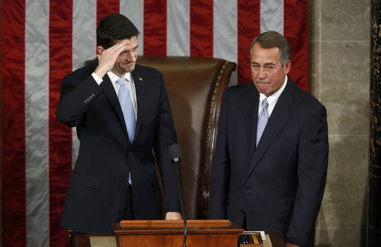 Incoming House Speaker Paul Ryan, R-Wis., salutes the members of the House as he stands with outgoing Speaker John Boehner, R-Ohio, after Ryan was elected on Capitol Hill in Washington Oct. 29. Ryan received 236 votes. (CNS photo/Gary Cameron, Reuters) 