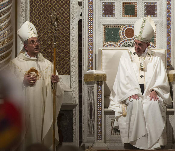 Pope Francis sits in the papal chair as he celebrates the ordination Mass of Bishop Angelo De Donatis, left, as an auxiliary bishop of Rome in the Basilica of St. John Lateran Nov. 9. (CNS photo/Claudio Peri, EPA)