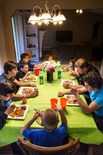 A family that chooses to watch TV or play with their smartphones rather than talk at the dinner table is "hardly a family," Pope Francis said. (CNS photo/Lisa Johnston, St. Louis Review)