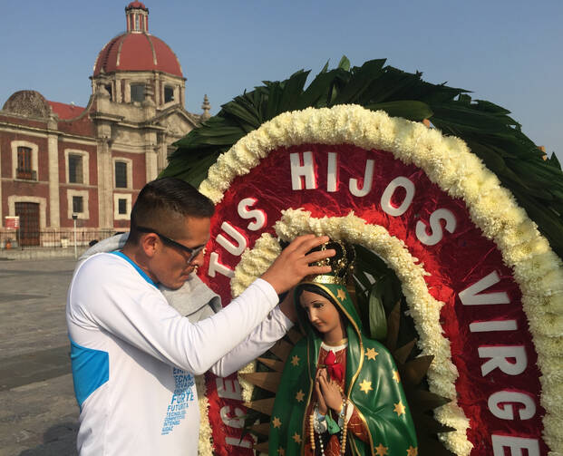 A man adjusts the crown on a statue of Our Lady of Guadalupe Dec. 6 outside the basilica named for her in northern Mexico City. The national patroness remains important in Mexico as source of spiritual inspiration, but even nonoreligious people identify with her. (CNS photo/David Agren)