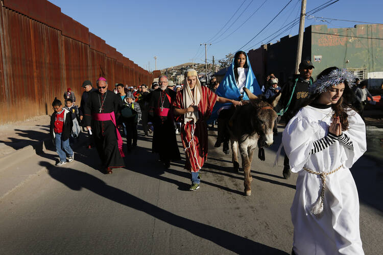 A "posada," the commemoration of Mary and Joseph's search for shelter, Dec. 20 along the international border fence in Nogales, Sonora. (CNS photo/Nancy Wiechec)