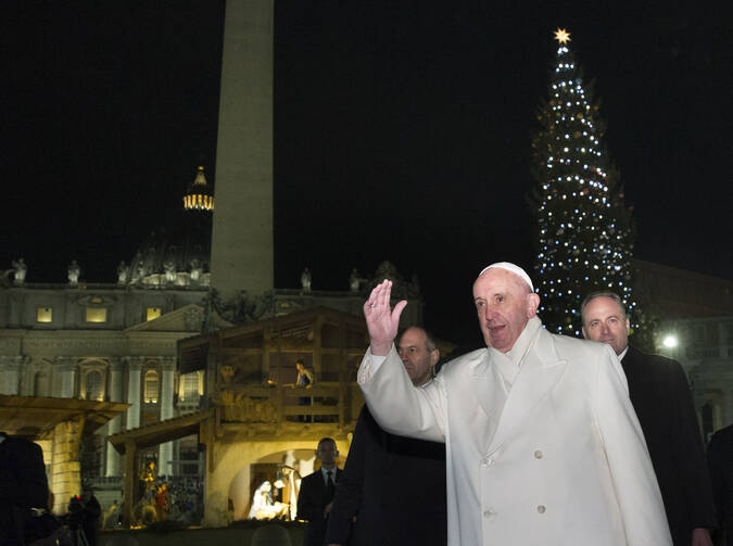Pope Francis greets the crowd in St. Peter's Square after visiting the Nativity scene in the square on New Year's Eve at the Vatican Dec. 31. (CNS photo/Paul Haring)