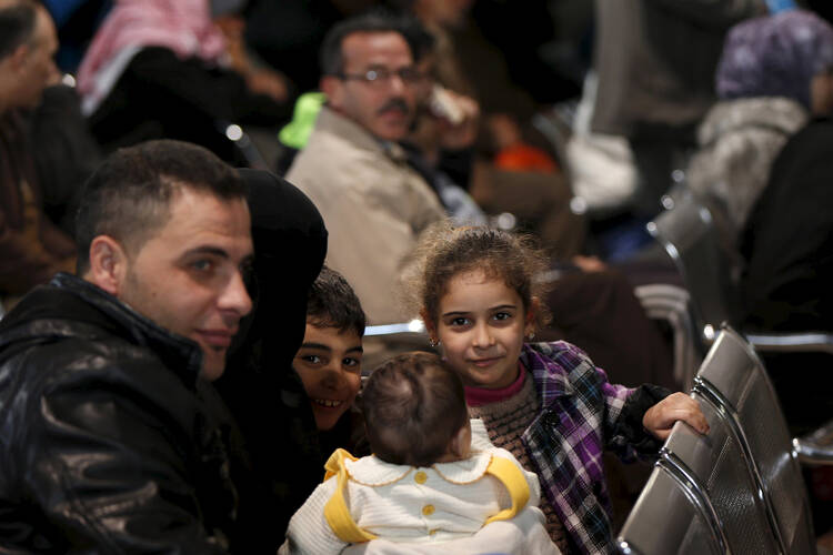Syrian refugees wait to register at the office of the U.N. High Commissioner for Refugees in Amman, Jordan, Dec. 11. More than 1,000 Syrian refugees in Jordan were interviewed for a potential chance to go to Canada. (CNS photo/Muhammad Hamed, Reuters)