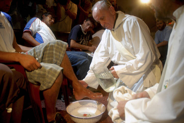 Cardinal Jorge Mario Bergoglio, who became Pope Francis, washes the feet of residents of a shelter for drug users during Holy Thursday Mass at a church in a poor neighborhood of Buenos Aires, Argentina, in 2008. Following a request by Pope Francis, the Vatican issued a decree Jan. 21 specifying that the Holy Thursday foot-washing ritual can include women. (CNS photo/Enrique Garcia Medina, Reuters)