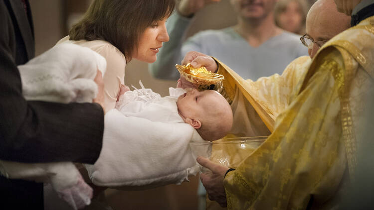 Oksana Vydash holds on to her goddaughter Veronika Victoria Shalai during her baptism at St. Mary's Assumption Ukrainian Catholic Church in St. Louis in this Jan. 12, 2013, file photo. (CNS photo/Lisa Johnston, St. Louis Review) 