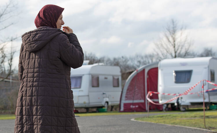 A refugee woman walks through the caravan park in Frankfurt, Germany, Feb. 12. (CNS photo/Alexander Heinl, EPA)