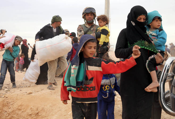 Syrian refugees arrive at a refugee camp in early May at the Jordan border with Syria. The Catholic Church in England and Wales has joined a government project to resettle an estimated 20,000 refugees from the Syrian war. (CNS photo/Jamal Nasrallah, EPA)