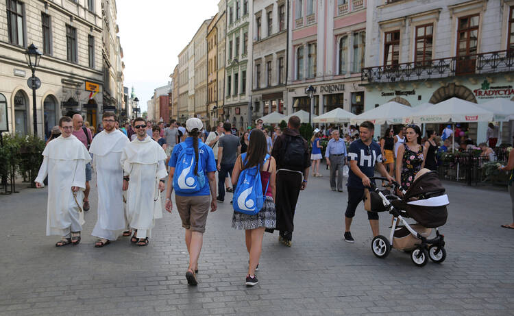 Men religious and other pilgrims walk along a street on July 24 in Krakow, Poland, ahead of World youth Day. (CNS photo/Bob Roller)