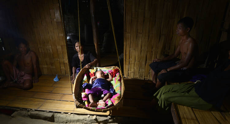 A Bru refugee family is seen in Kanchanpur, India on June 18. (CNS photo/Stringer, EPA)