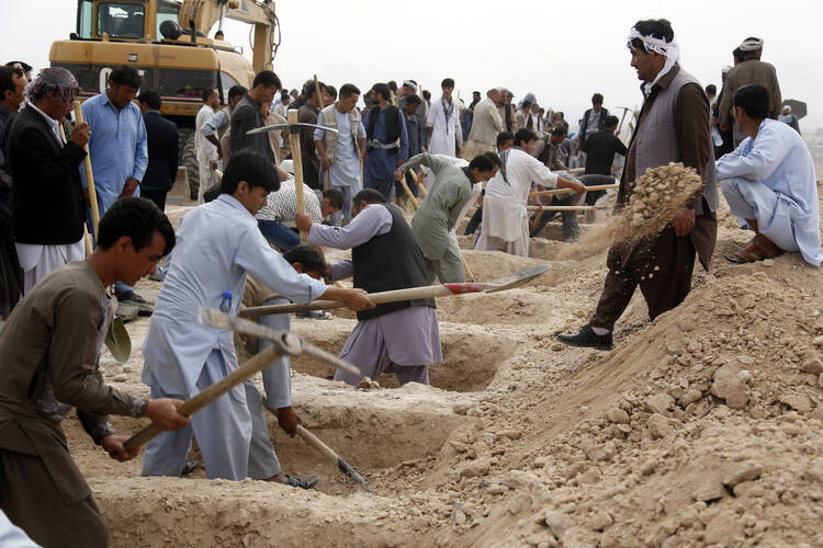 People dig graves July 24 for victims of a suicide bomb attack in Kabul, Afghanistan. The U.S. State Department's annual report on international religious freedom highlights Muslim violence against other Muslims. (CNS photo/Jawad Jalali, EPA)
