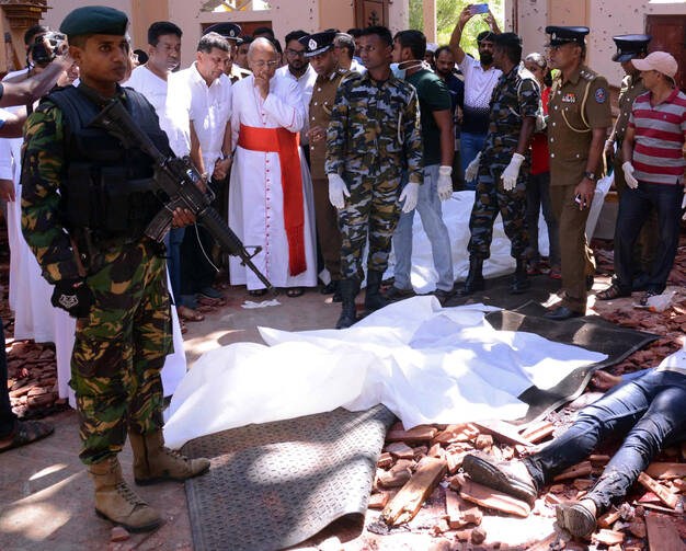 Cardinal Malcolm Ranjith of Colombo, Sri Lanka, looks at the explosion site inside a church in Negombo April 21, 2019, following a string of suicide bomb attacks on churches and luxury hotels across the island. (CNS photo/Reuters) 