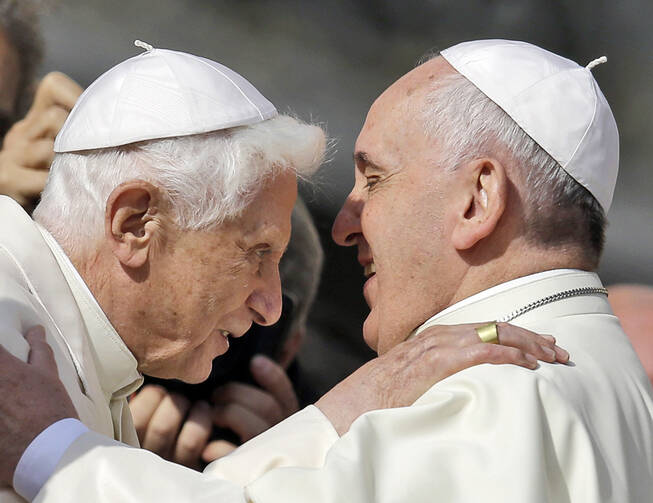 Pope Francis hugs Pope Emeritus Benedict XVI prior to the start of a meeting with elderly faithful in St. Peter's Square at the Vatican, Sunday, Sept. 28, 2014.