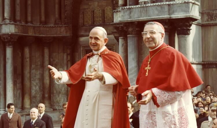 Pope Paul VI and the future Pope John Paul stand side-by-side before a crowd