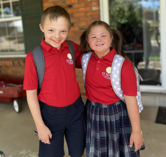 Two students with Down syndrome pictured in Catholic school uniforms
