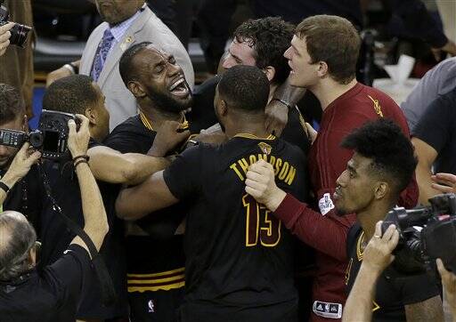 Cleveland Cavaliers forward LeBron James (23) hugs Kyrie Irving after Game 7 of basketball's NBA Finals against the Golden State Warriors. The Cavaliers won 93-89. (AP Photo/Eric Risberg)