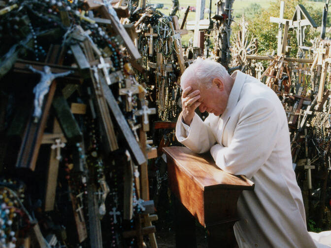 Pope John Paul II prays in 1993 at the Hill of Crosses in Siauliai, Lithuania. Pope Francis will make the same three-nation visit, stopping at a number of the same places as his saint-predecessor. (CNS photo/Arturo Mari, L'Osservatore Romano) 