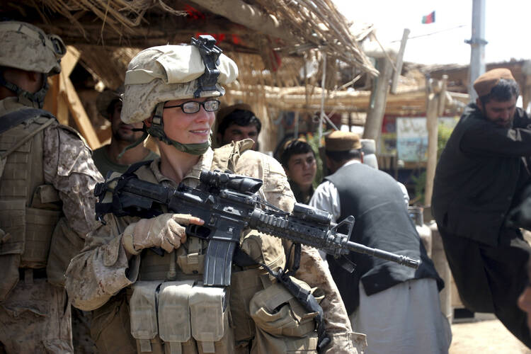 U.S. female soldier speaks with civilians during 2010 engagement mission in Afghanistan