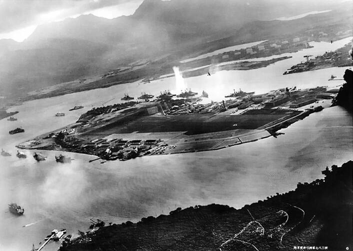 Photograph taken from a Japanese plane during the torpedo attack on ships moored on both sides of Ford Island shortly after the beginning of the Pearl Harbor attack. (Photo from Wikimedia Commons)