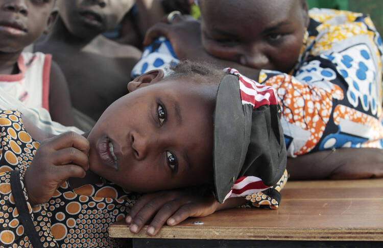 Girl displaced as a result of Boko Haram attack in Nigeria rests her head on desk at camp for displaced people, Jan. 20, 2015 (CNS photo/Afolabi Sotunde, Reuters). 