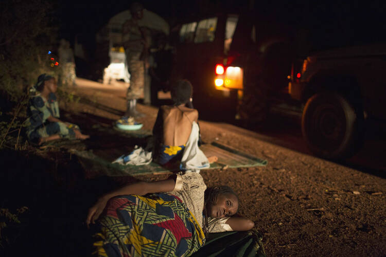 Women rest along the road in April during their journey towards Chad's border escorted by African Union soldiers in Central African Republic.