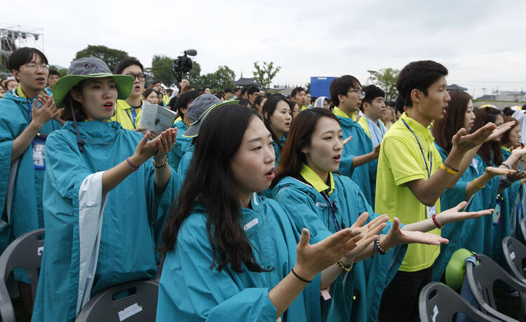 Young people pray as Pope Francis celebrates the closing Mass of the sixth Asian Youth Day at Haemi Castle in Haemi, South Korea, Aug. 17 (CNS photo/Paul Haring) .