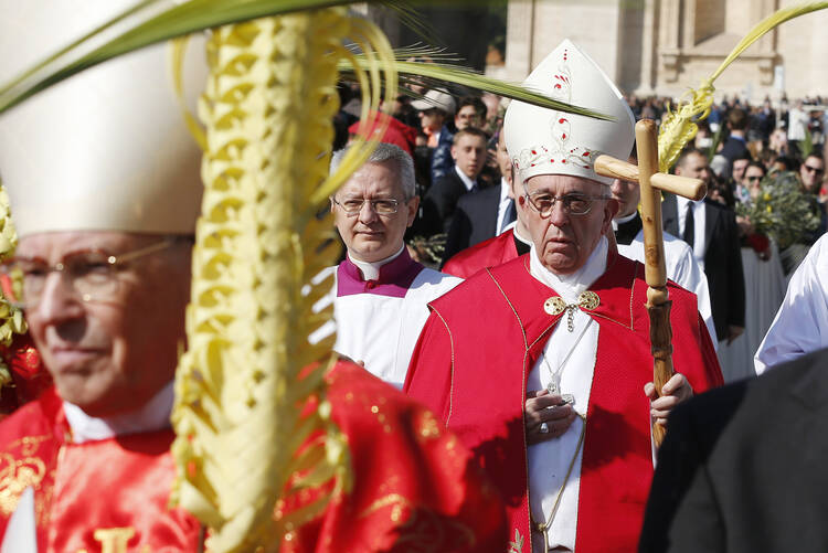 Pope Francis arrives in procession to celebrate Palm Sunday Mass in St. Peter's Square at the Vatican, March 20 (CNS photo/Paul Haring). 