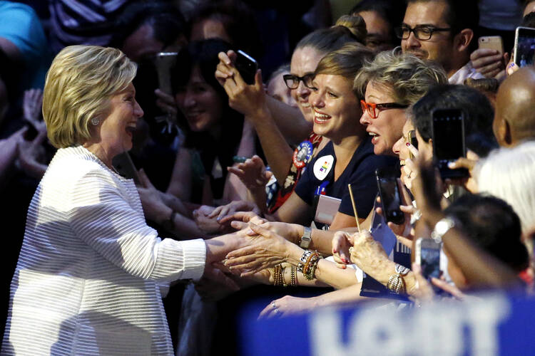 Democratic presidential candidate Hillary Clinton, left, is greeted by supporters as she arrives to a presidential primary election night rally, Tuesday in New York. (AP Photo/Julio Cortez)