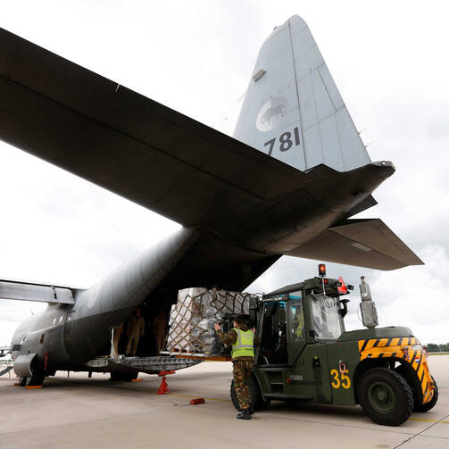 A transport aircraft at Eindhoven Airbase in Eindhoven, Netherlands, is loaded with relief supplies for victims of the humanitarian disaster in Iraq, Aug. 2014 (CNS photo/Bas Czerwinski, EPA).