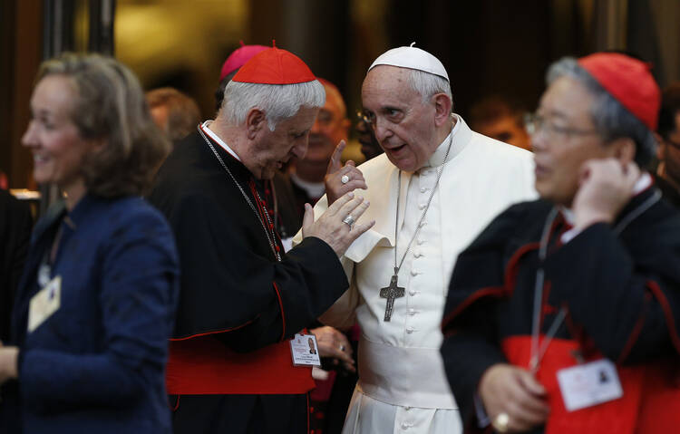Pope Francis talks with Italian Cardinal Giuseppe Versaldi as they leave the concluding session of the extraordinary Synod of Bishops on the family at the Vatican Oct. 18. (CNS photo/Paul Haring) 