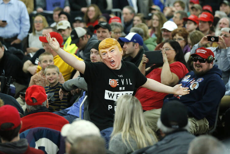 A not-necessarily-anxious man wears a Donald J. Trump mask at the Republican presidential candidate's rally ol Saturday in Rothschild, Wis. (AP Photo/Charles Rex Arbogast)