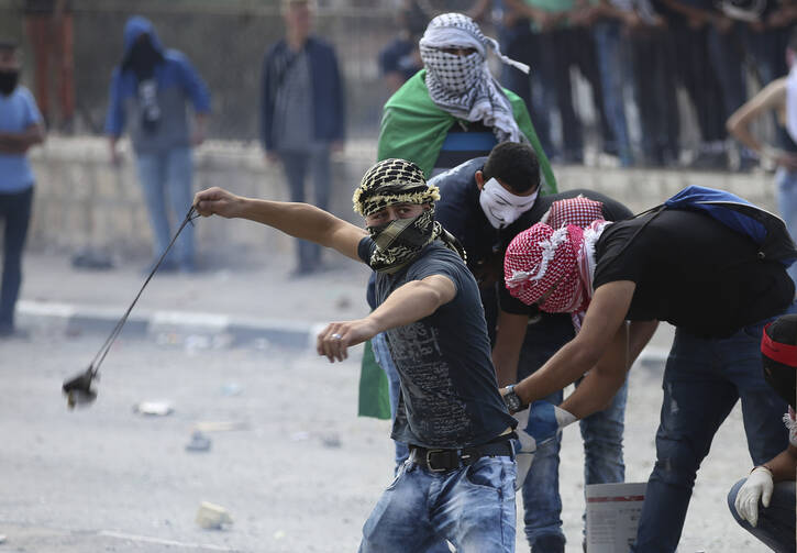 Palestinian protesters clash with Israeli soldiers in Bethlehem, West Bank, Oct. 6. Violence in Israel and the West Bank has increased in October.(CNS photo/Abed Al Haslhamoun, EPA) 