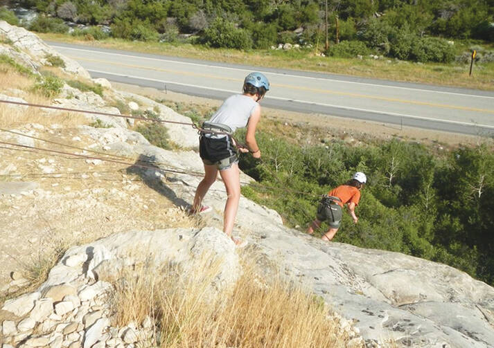 CLIFFHANGER. The author, right, rappelling Australian style near Wyoming Catholic College.