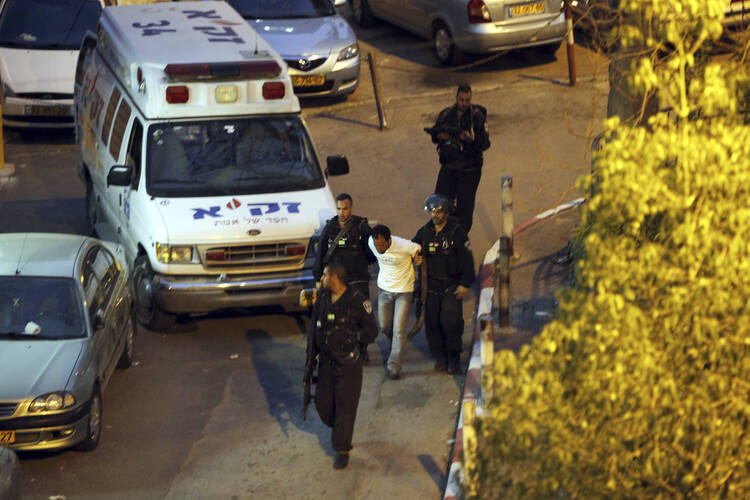 sraeli policemen arrest a Palestinian after a shooting attack in Jerusalem Tuesday, March 8, 2016. A Palestinian opened fire and wounded two police officers before he was shot an killed, police said. (AP Photo/Mahmoud Illean)