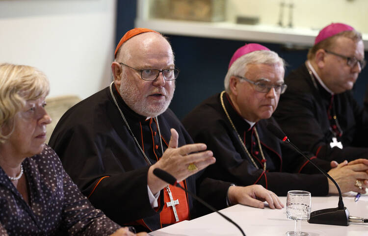 Cardinal Reinhard Marx of Munich-Freising and other German bishops and a lay synod observer, hold a press conference at the Vatican after the opening session of the Synod of Bishops on the family at the Vatican, Oct. 6 (CNS photo/Paul Haring).