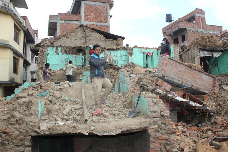 Earthquake survivors of Safal Tol village on the outskirts of Kathmandu, Nepal, retrieve belongings from their destroyed homes April 29, five days after a major earthquake struck the region. (CNS photo/Anto Akkara) 